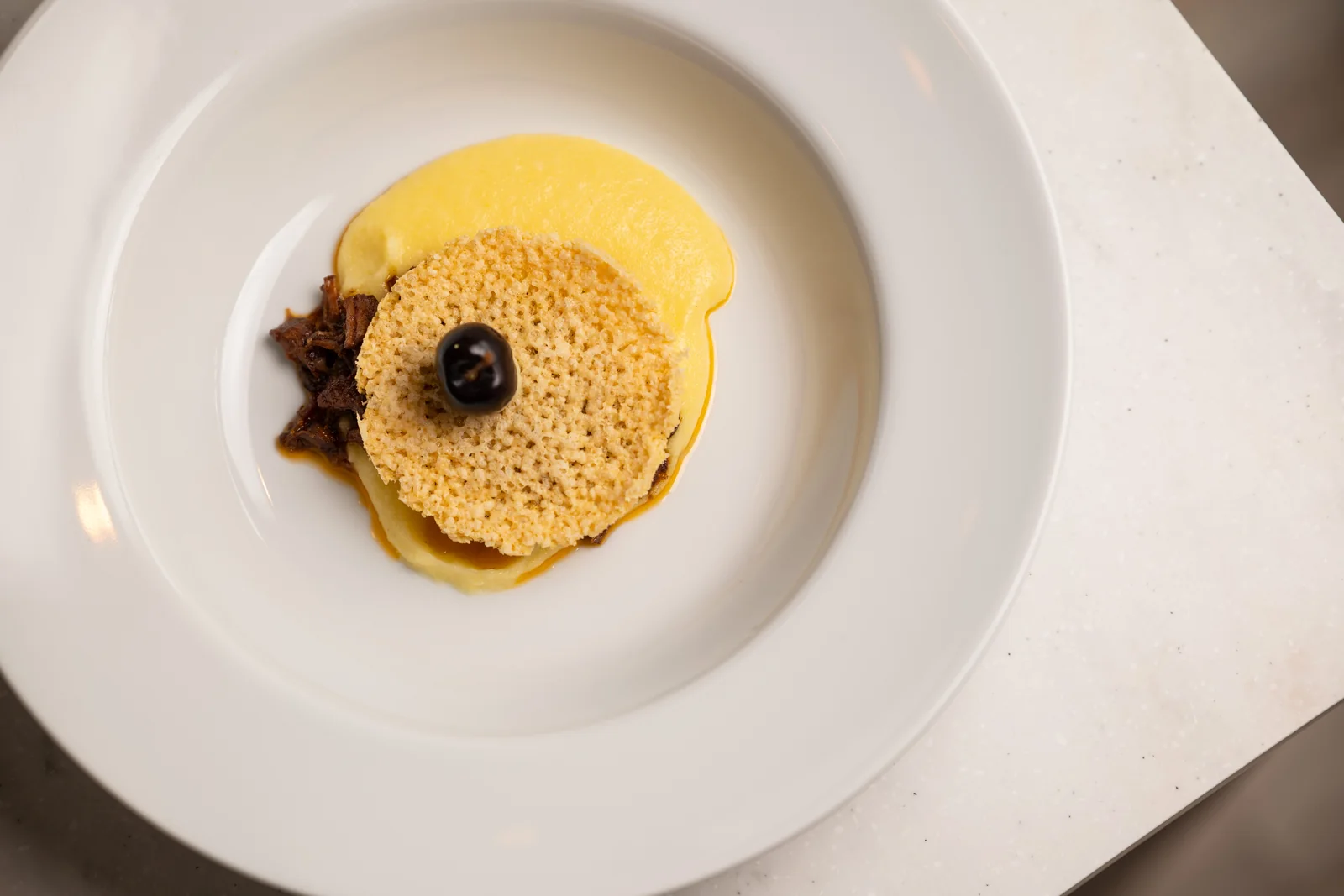 Savoury fine dining course with pear and a delicate crisp